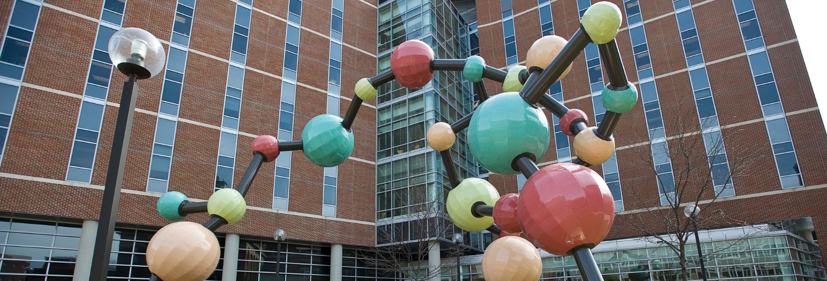 Large molecule statue outside Twin Cities campus building