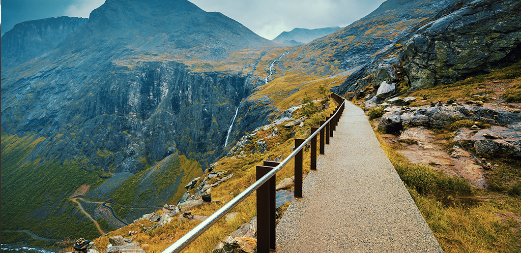 An empty walking path along a mountainside