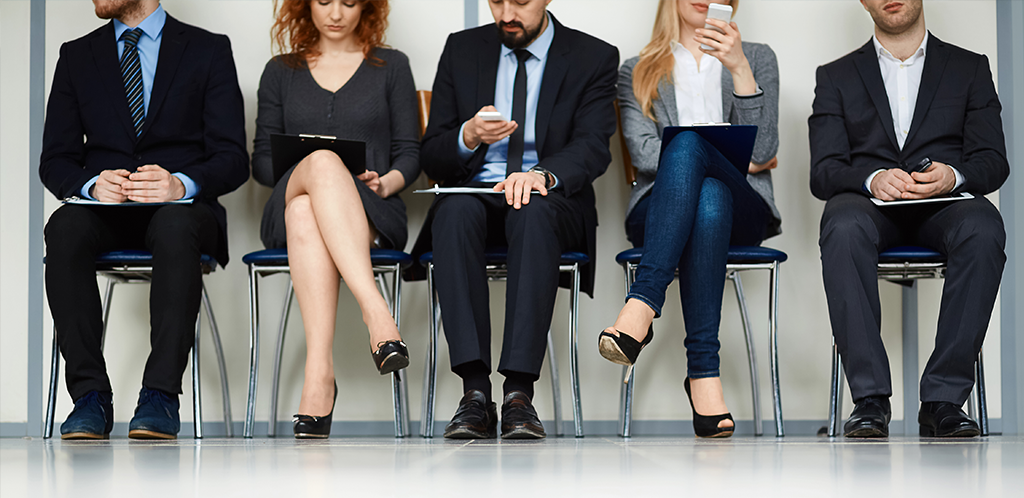 People sitting in chairs waiting for an interview